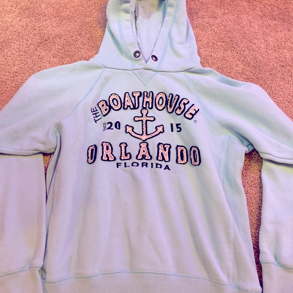 Light blue Orlando boathouse sweatshirt.